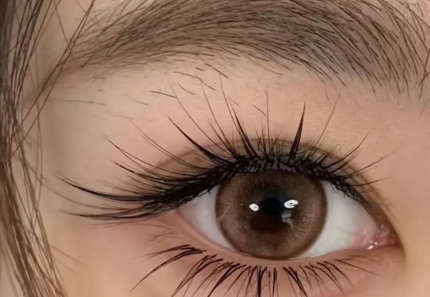 Close-up result of an iconic wispy lash set with dramatic separated spikes